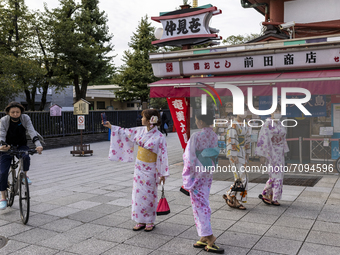 07/09/2021 Tokyo, Japan. 
Young people dressed in traditional clothes pose for selfies in the street of Asakusa leading to the  Sensō-Ji, a...