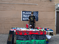 A member of the National Association for Black Veterans, tables at CurbFest for the liberation of political prisoners held by the United Sta...