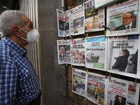 A man watches newspapers reporting the death of former Algerian President Abdelaziz Bouteflika in Algiers, Algeria, September 19, 2021 (