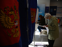 A woman at a polling station during voting in the State Duma of the Russian Federation in St. Petersburg. Saint Petersburg, Russia, Septembe...