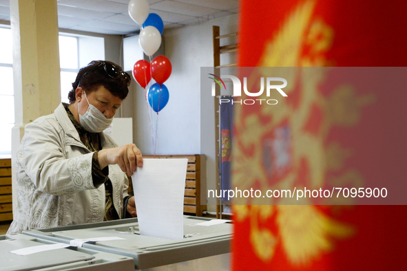 A woman at a polling station during voting in the State Duma of the Russian Federation in St. Petersburg. Saint Petersburg, Russia, Septembe...