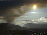 Flaming hill and rising smoke over the city of Ourense as another fire is being controlled by the local firefighter sevices. Ourense, Galici...