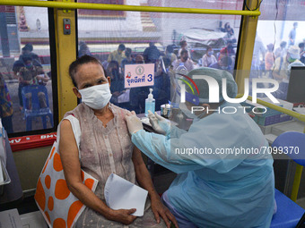 An elderly woman receives a dose of AstraZeneca COVID-19 vaccine in a vehicle of the BKK Mobile Vaccination Unit on September 20, 2021 in Ba...