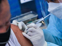 A man receives a dose of AstraZeneca COVID-19 vaccine in a vehicle of BKK Mobile Vaccination Unit on September 20, 2021 in Bangkok, Thailand...