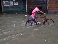 A cyclist is seen waded through a water logged street in Kolkata as many parts of West Bengal including the capital city of Kolkata, witness...