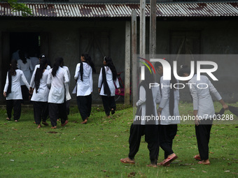 Students of class Xth arrives in a school after Assam state government resumes classes for class 10th students, on 20 September 2021 in Barp...