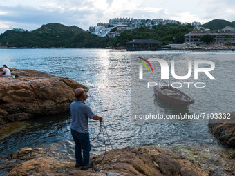 A local resident moors his boat near rocks in Stanley, in Hong Kong, China, on September 19, 2021. (