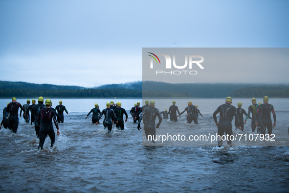 Athletes enter in the cold water, at Swedeman 2021 in Åre, Sweden 