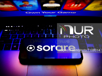 Sorare logo displayed on a phone screen and Sorare website displayed on a laptop screen are seen in this illustration photo taken in Krakow,...