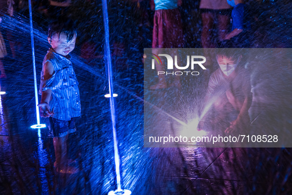 Hong Kong, China, 21 Sep 2021,  Children play in the Kwun Tong musical fountain on Mid-Autumn festival. 