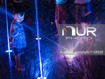 Hong Kong, China, 21 Sep 2021,  Children play in the Kwun Tong musical fountain on Mid-Autumn festival. (