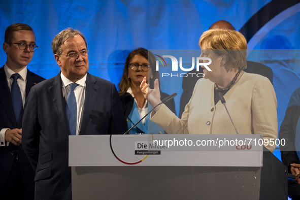 German Chancellor Angela Merkel and chancellor candidate of Germany's conservative Christian Democratic Union (CDU) party Armin Laschet atte...