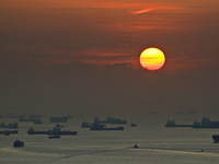 The sun rises as vessels are seen anchored along the southern coast on September 22, 2021 in Singapore.  (