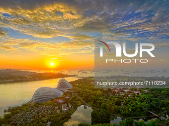 (EDITORS NOTE: Image is a digital composite) A general view at sunrise of the Flower Dome, Cloud Forest and Supertree Grove at the Gardens b...
