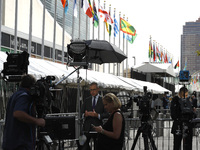 Television media broadcast commentaries as delegates arrive to the United Nations 76th General Assembly amid protests  on September 21, 2021...