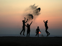 Palestinian boys play during sunset in northern Gaza Strip, on September 21, 2021.
 (