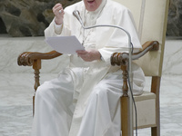 Pope Francis sits during his weekly general audience in the Paul VI Hall at the Vatican, Wednesday, Sept. 22, 2021. (