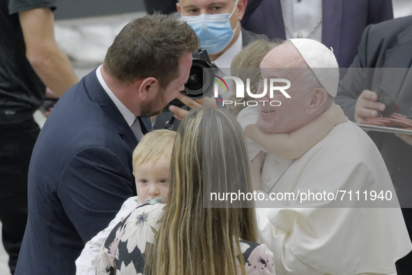 Pope Francis meets a family as he leaves after his weekly general audience in the Paul VI Hall at the Vatican, Wednesday, Sept. 22, 2021. 
