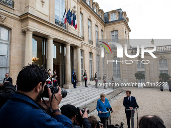 French President Emmanuel Macron welcomes German Chancellor Angela Merkel at the Elysee Presidential Palace on September 16, 2021 in Paris,...