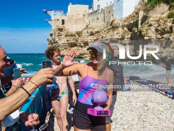 Divers greet the public asking for a photo in Polignano a Mare during the Red Bull Cliff Diving 2021 at Lama Monachile on September 22, 2021...
