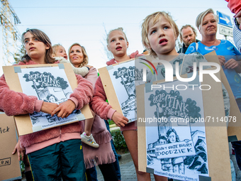 A group of children are holding placards that say in Dutch 'this factory stinks, makes our neighborhood very sick,' during a demonstration a...