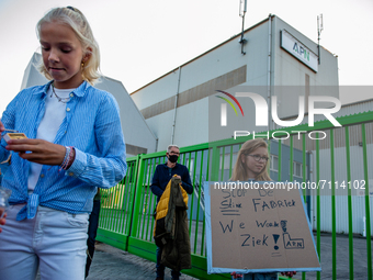 A little children is holding a placard against the factory while standing up in front of the door, during a demonstration against the APN as...