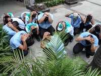 Libis, Quezon City Philippines - Office workers duck and take cover during the nationwide earthquake drill in Libis, Quezon City on Thursday...