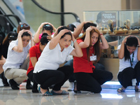 MANILA, Philippines - Filipinos perform the “drop, cover, and hold” action during the metro wide earthquake drill at one of the participatin...