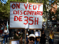A youth leader holds a placard reading 'We want a 35 hours contract' .Teachers on strike protested in Toulouse as other cities in France aga...