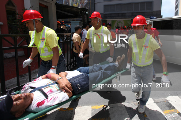 Libis, Quezon City Philippines - An injured man is rushed for medical assistance during the nationwide earthquake drill in Libis, Quezon Cit...