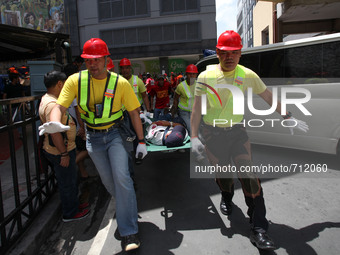 Libis, Quezon City Philippines - An injured man is rushed for medical assistance during the nationwide earthquake drill in Libis, Quezon Cit...