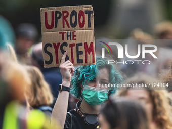 Protesters take part in a climate protest as they march though the city centre on September 24, 2021 in Glasgow, Scotland. Thousands of peop...