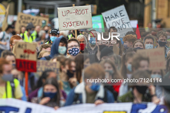 Protesters take part in a climate protest as they march though the city centre on September 24, 2021 in Glasgow, Scotland. Thousands of peop...