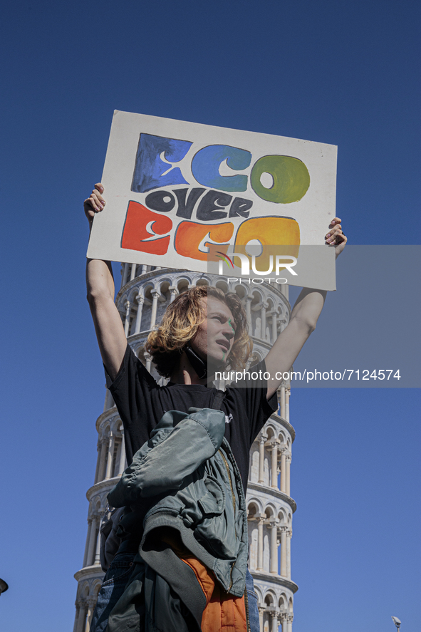 People attending the 24th September global climate strike organized by the Friday For Future movement in front of the leaning tower in Pisa,...