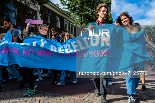 A group from XR University is holding a big banner, during the Global Climate Strike organized in Utrecht, on September 24th, 2021. 