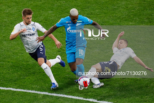 Malcom (C) of Zenit vies for the ball with Iuriy Gorshkov (L) and Denis Yakuba of Krylia Sovetov during the Russian Premier League match bet...