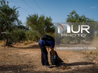 A volunteer from the Terrae Association cleans up the green lung of the city Lama Martina during the National Plastic Free Day in Molfetta o...