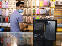 A Palestinian venedor displays Apple's new iPhone13 at a mobile phone store in Gaza City on September 28, 2021. 
 (