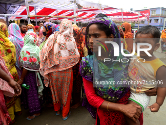 Slum People wait to receive a dose of Sinopharm COVID-19 vaccine at a makeshift vaccination center at Korail Slum in Dhaka, Bangladesh, on S...