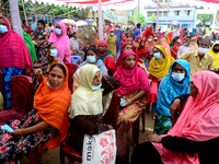 Slum People wait to receive a dose of Sinopharm COVID-19 vaccine at a makeshift vaccination center at Korail Slum in Dhaka, Bangladesh, on S...