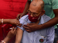 Slum people receive a dose of Sinopharm COVID-19 vaccine at a makeshift vaccination center at Korail Slum in Dhaka, Bangladesh, on September...