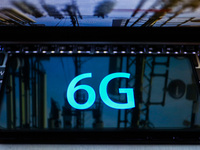 6G sign is seen on the smartphone screen with the reflection of telecommunication towers in this  illustration photo taken in Krakow, Poland...