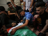 (EDITOR'S NOTE: Graphic Content) Mourners attend the funeral of Palestinian Mohammad Abu Ammar, who was killed by Israeli troops at the Isra...