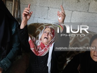 Mourners react before the funeral of Palestinian Mohammad Abu Ammar, who was killed by Israeli troops at the Israel-Gaza border fence, accor...