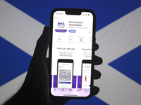 Scotland’s Vaccine Passport App is seen on a smartphone screen with the Scottish Saltire flag in the background in this illustration photo t...
