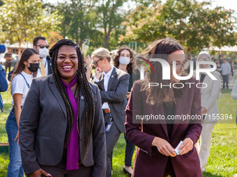 Congresswomen Cori Bush (D-MO) and Alexandria Ocasio-Cortez (D-NY) share a laugh as they speak at a protest at the US Capitol, hosted by Peo...