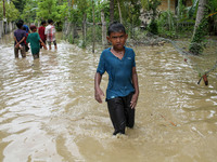 A child is seen walking through a flood caused by a river overflowing after heavy rains in North Aceh, on October 1, 2021, Aceh Province, In...