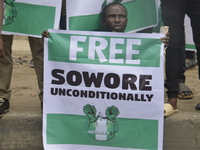 A protester holding a banner with the inscription “FREE SOWORE UNCONDITIONALY” during demanding the resignation of the President, Muhammadu...