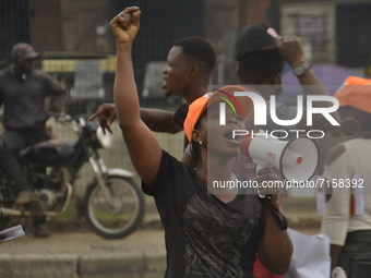 A woman reacts during a protest demanding the resignation of the President, Muhammadu Buhari in a protest in the Ojota district of Lagos, Ni...