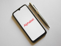 In this photo illustration an Alphabet logo is display on a smartphone screen and a pencil in Athens, Greece on October 4, 2021. (